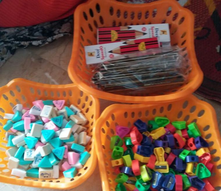 Educational supplies and materials organized in baskets for distribution